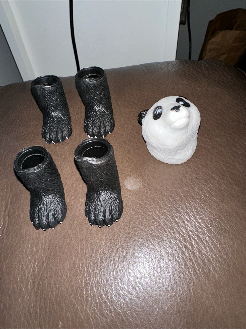 Plastic panda head with four feet